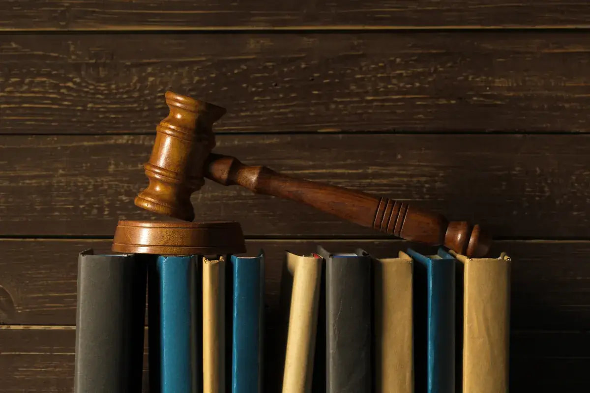 A judge's gavel resting on a row of law books