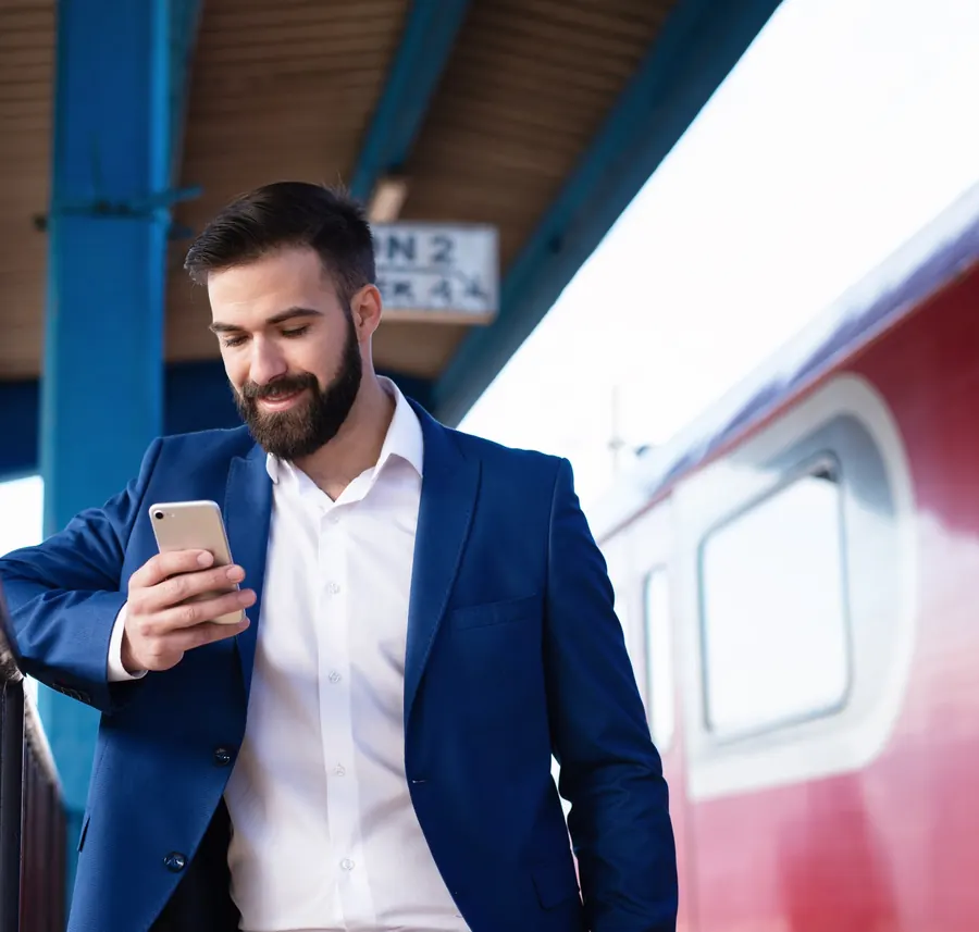 A future agent in a suit revising on his phone on a station platform